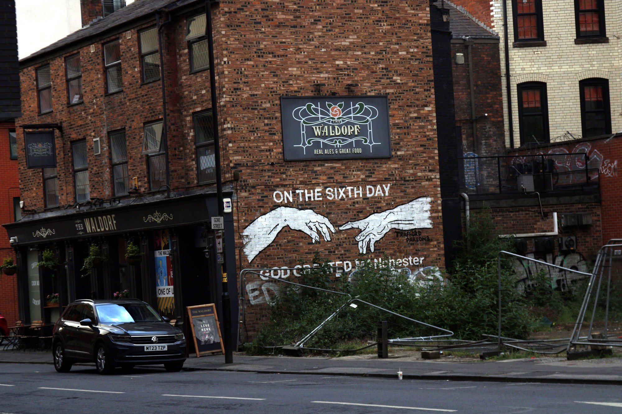 The Waldorf pub with an ‘On the sixth day’ mural painted on its brick side wall