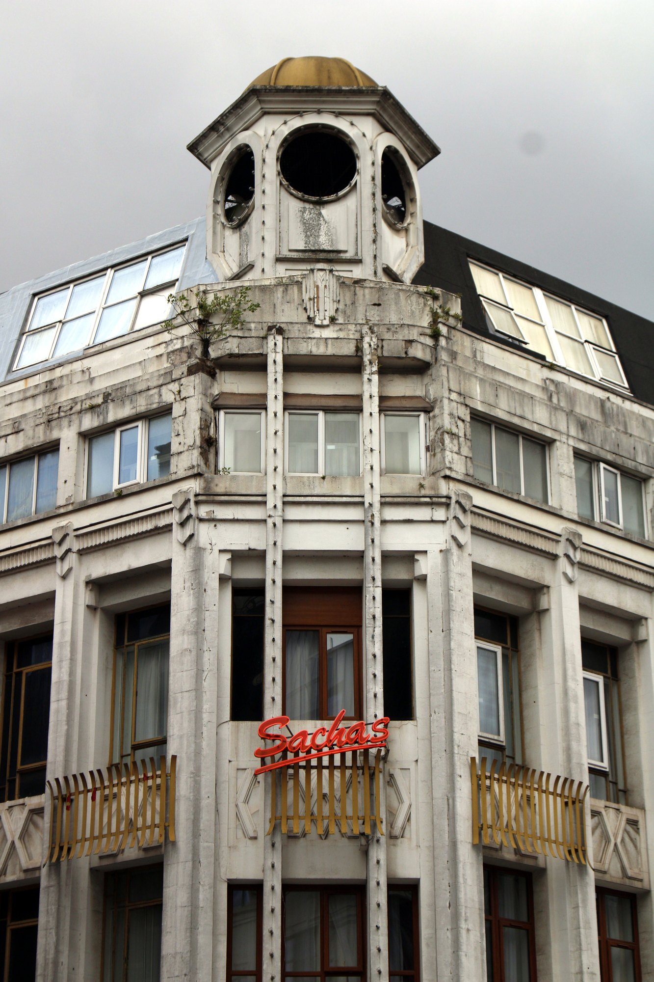 White corner building topped with a small domed clock tower