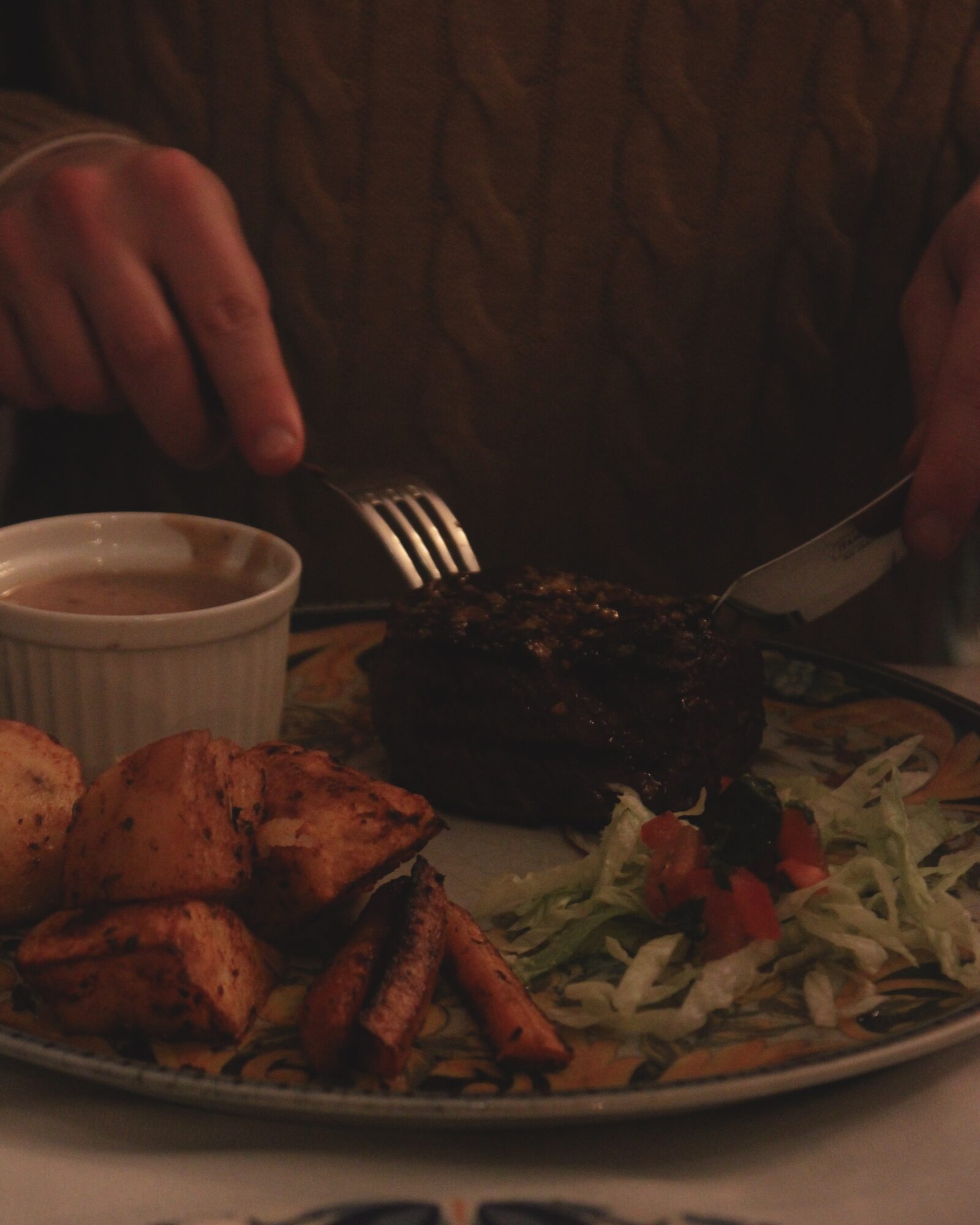 Steak dinner being carved at the table
