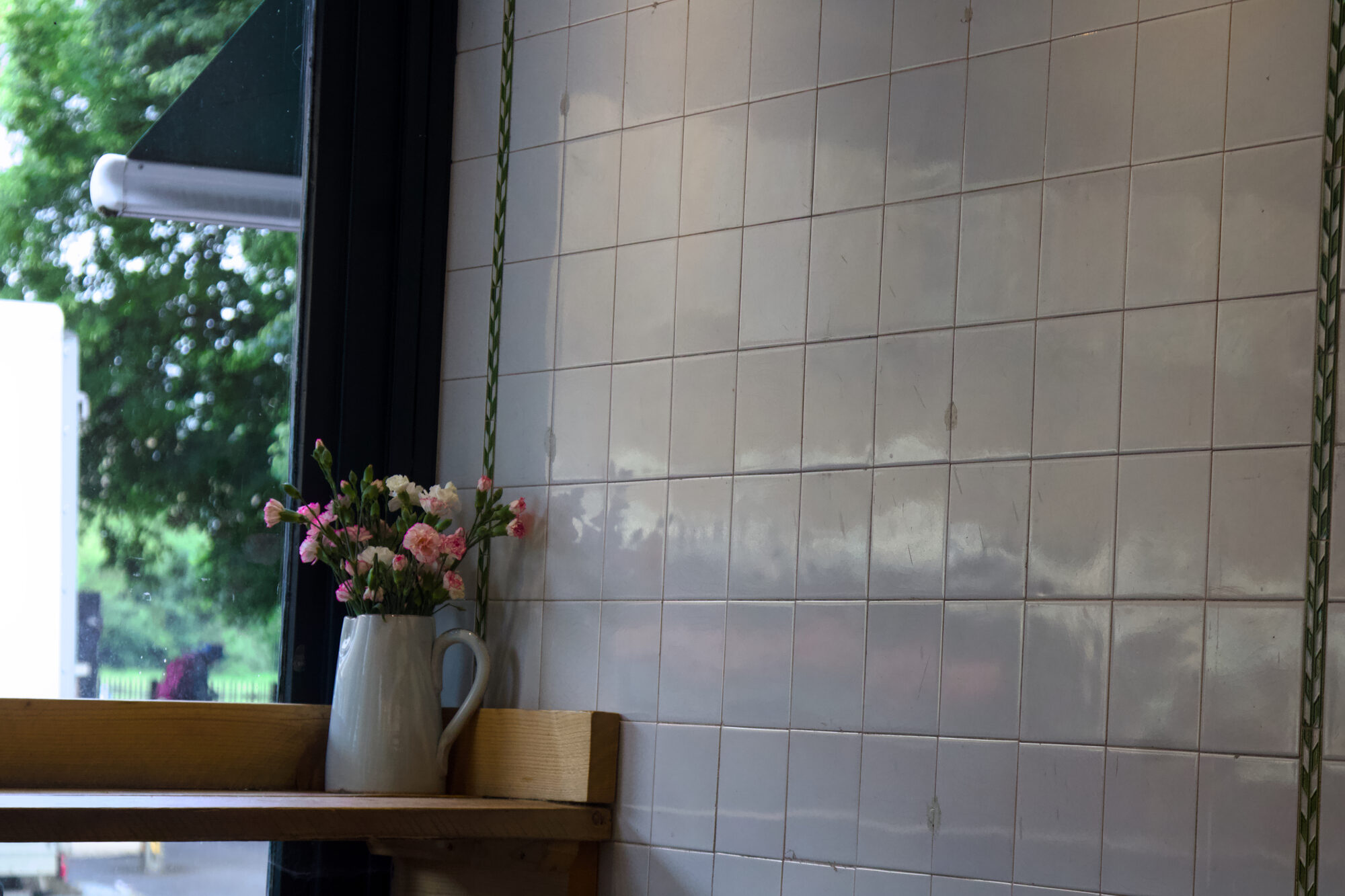 Cafe window seat with fresh flowers